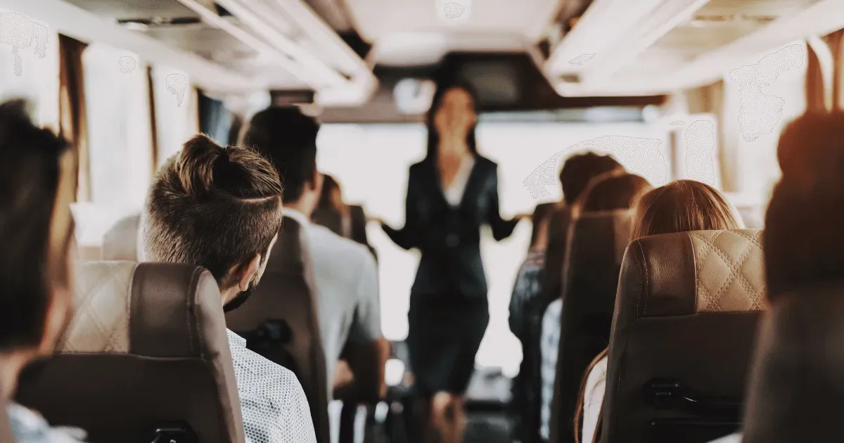 Guide speaking to passengers on board a coach bus