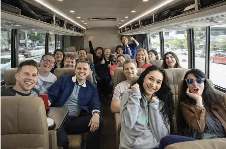 Smiling passengers on board a Swoop shuttle bus
