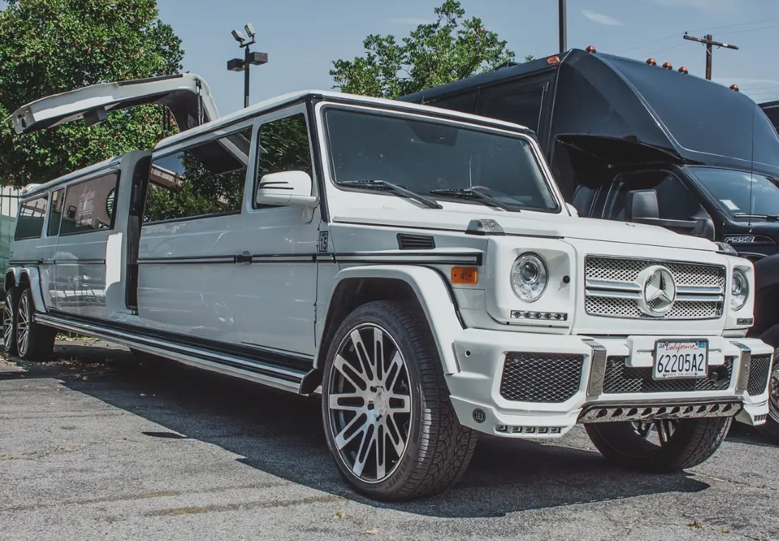Limousine dallas white mercedes next to black van