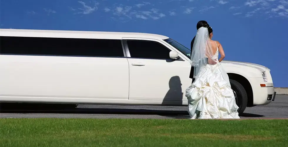 Wedding limousine white with blue sky and green grass