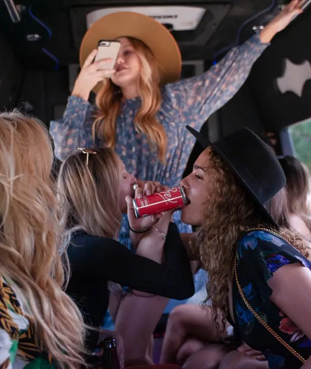 Friends celebrating inside a party bus