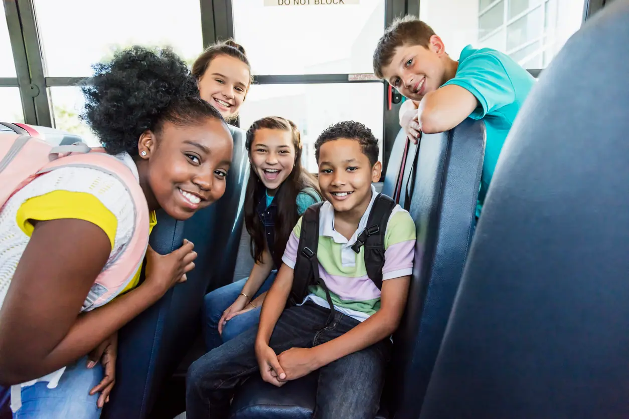 Private school students traveling on school bus