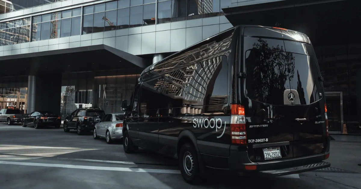 City transit sprinter van outside of office building