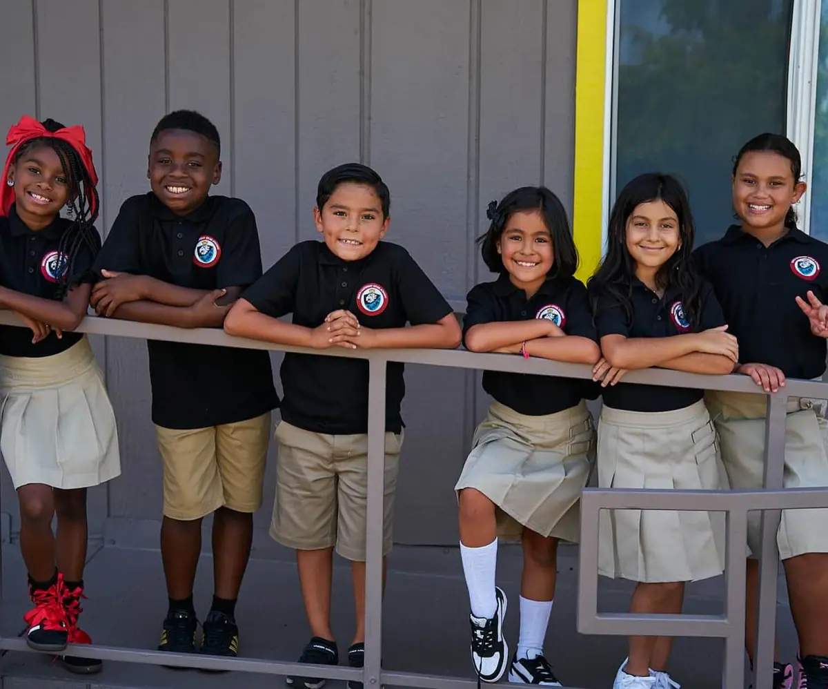 Smiling students in school uniforms
