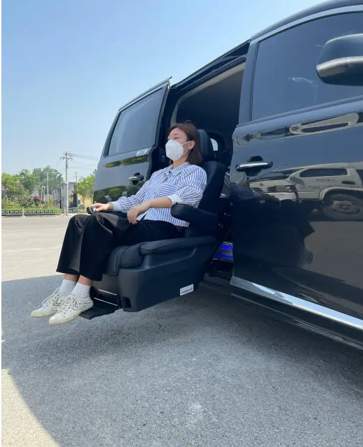 Passenger seated in the swivel seat of an accessible van