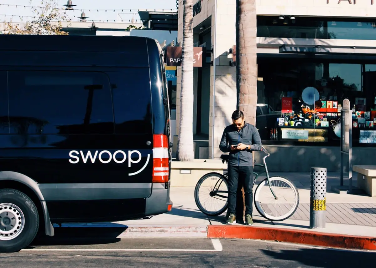 Black Swoop van parked outside a cafe