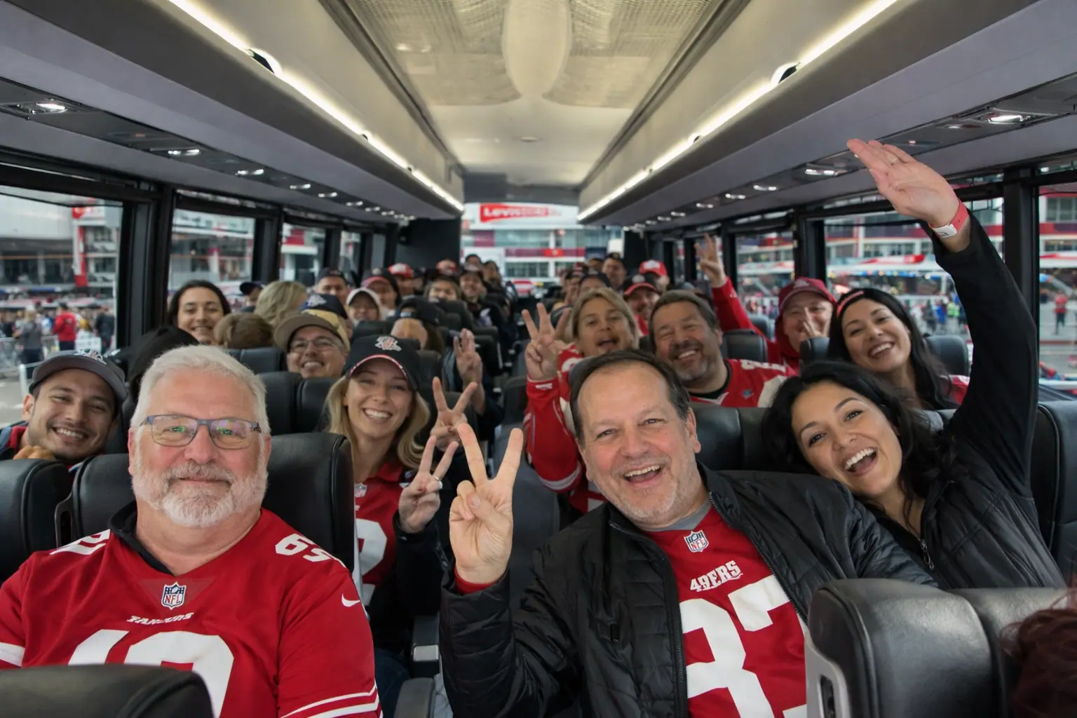 49ers fans cheering on board a charter bus