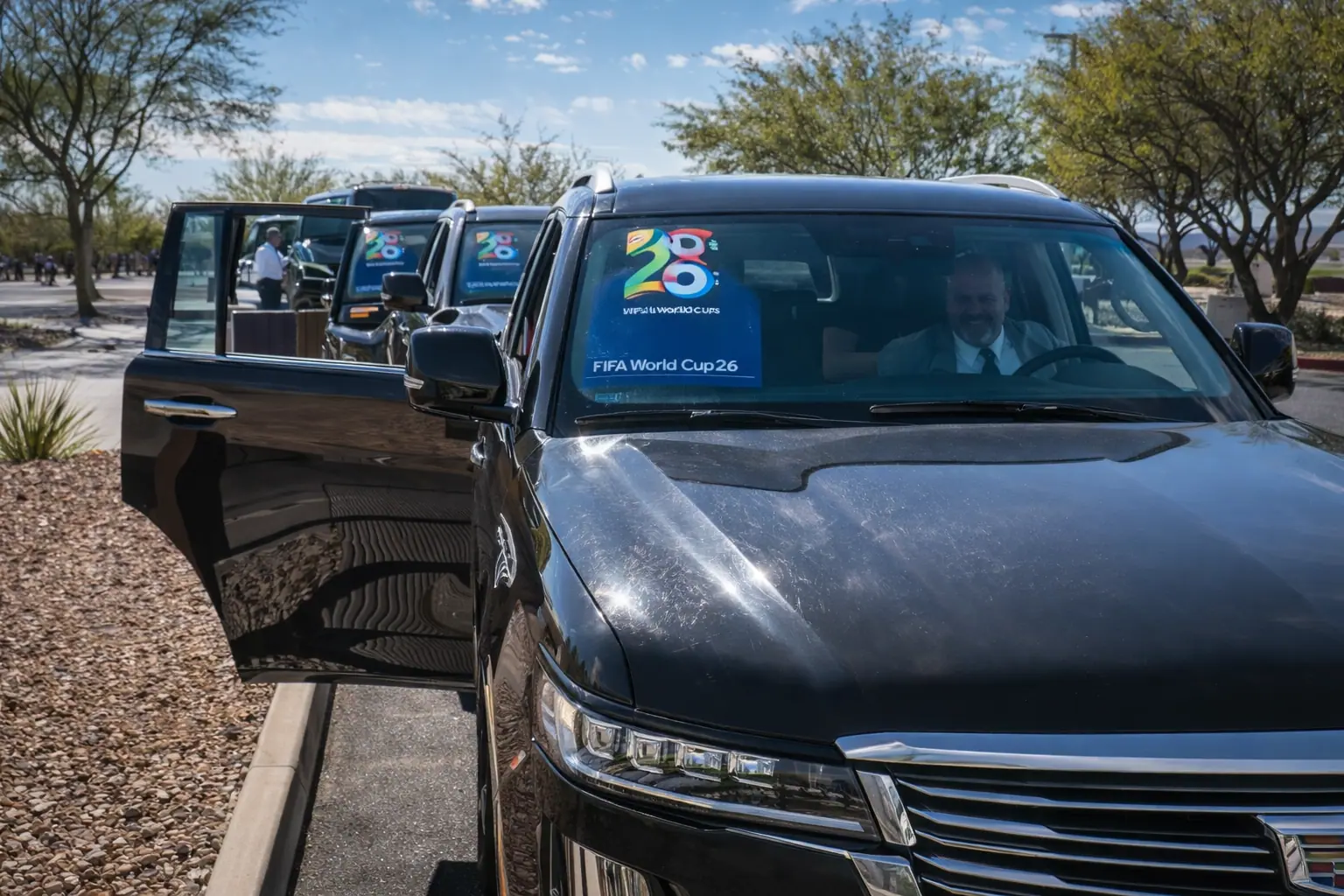 Black SUVs with FIFA World Cup 26 signage lined up for pickup